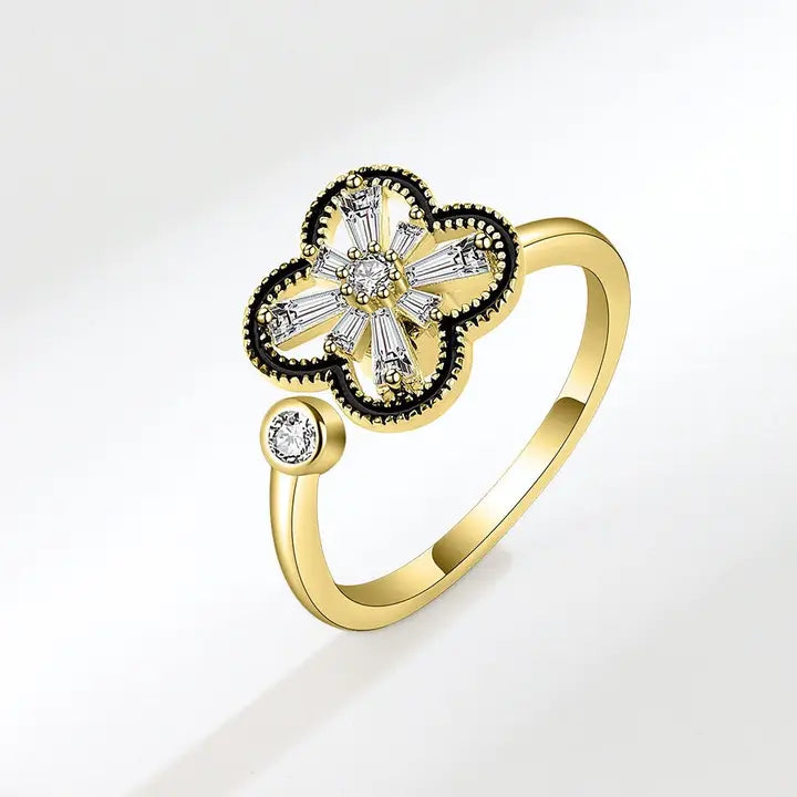 Gold ring with diamond accents on a white background