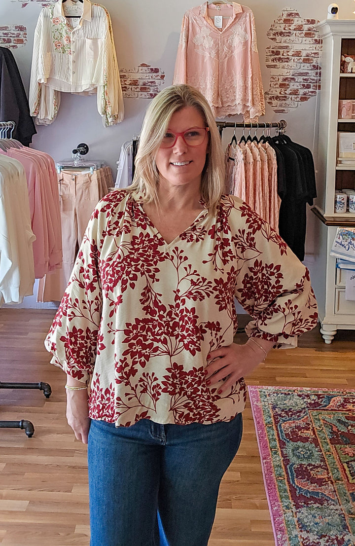 Woman wearing a floral blouse in a clothing store