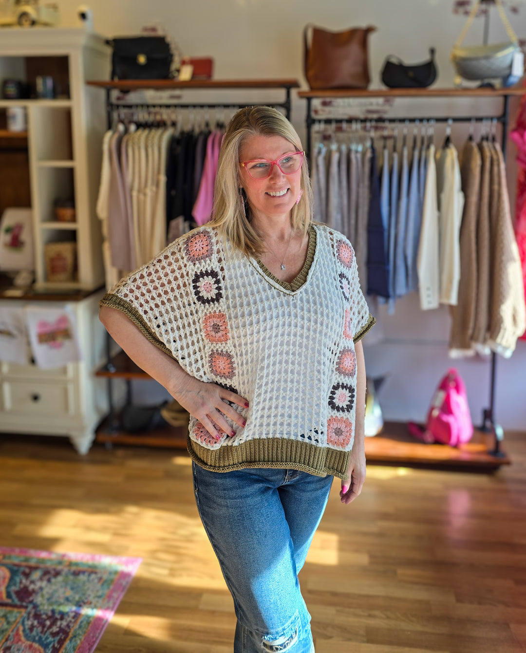 Woman wearing a patterned poncho in a clothing store