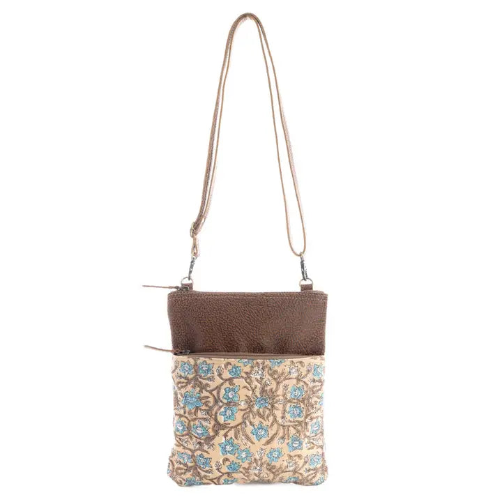 Crossbody bag with floral pattern and brown top section on a white background