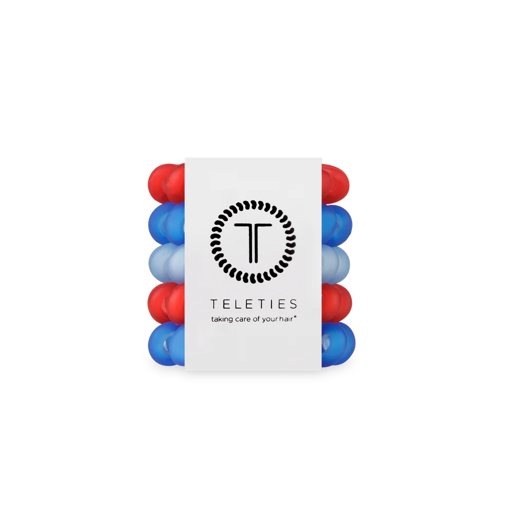 Set of red and blue hair ties with a white label displaying the brand &