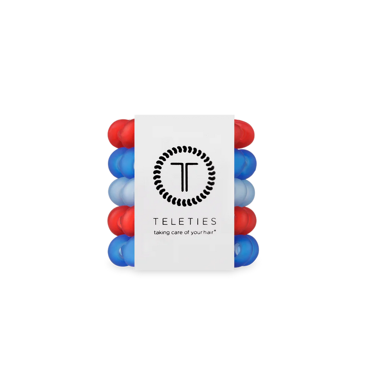 Set of red and blue hair ties with a white label displaying the brand &