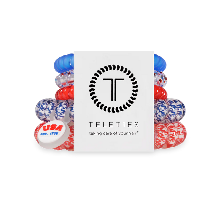 Set of red, white, and blue hair ties with Teleties packaging on a white background
