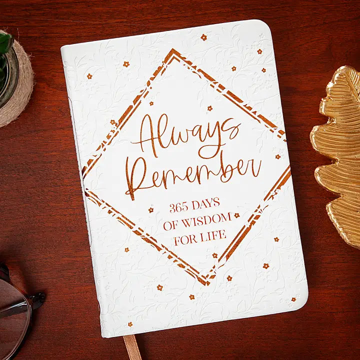 Notebook with 'Always Remember' quote on a wooden surface