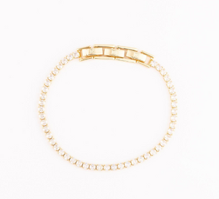 Gold bracelet on a white background