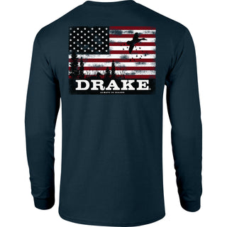 A dark navy long-sleeve t-shirt shown from the back, featuring a large graphic print of a distressed American flag with a silhouette of a person and the word 'DRAKE' in bold white letters.