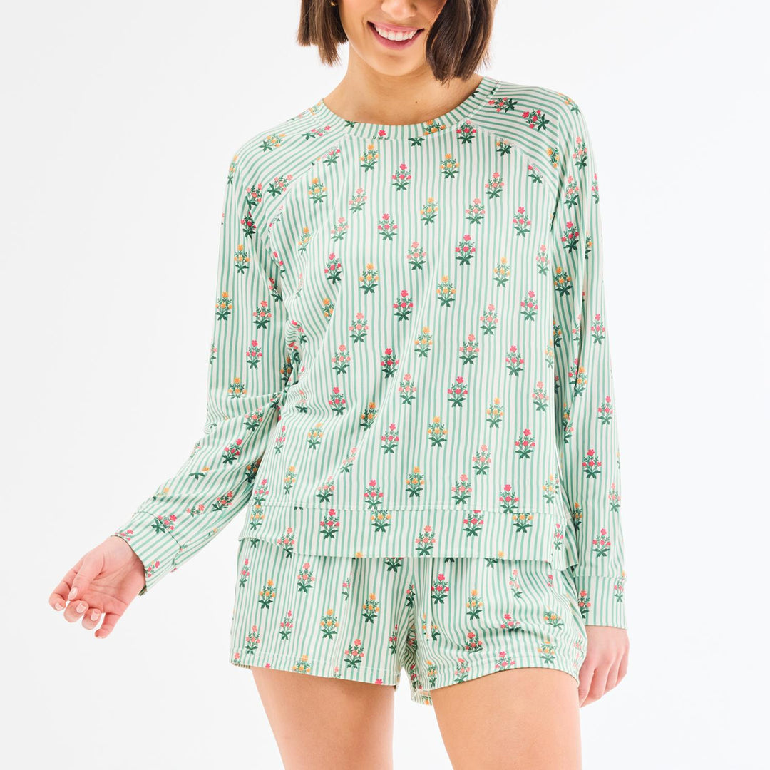 green striped pajama set with long sleeve crewneck top and shorts and pink and yellow floral details