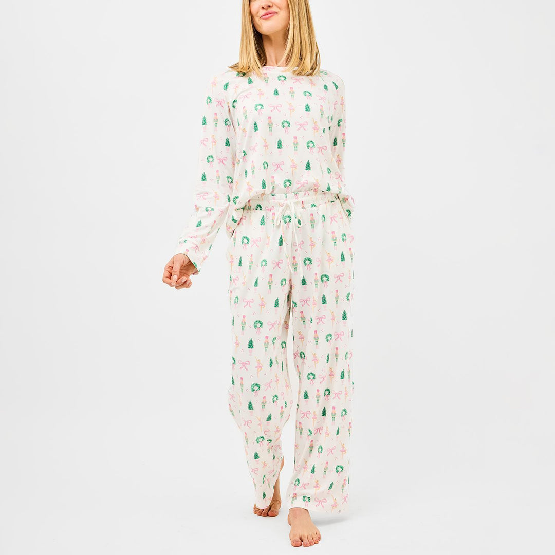 Woman wearing a floral pajama set on a white background