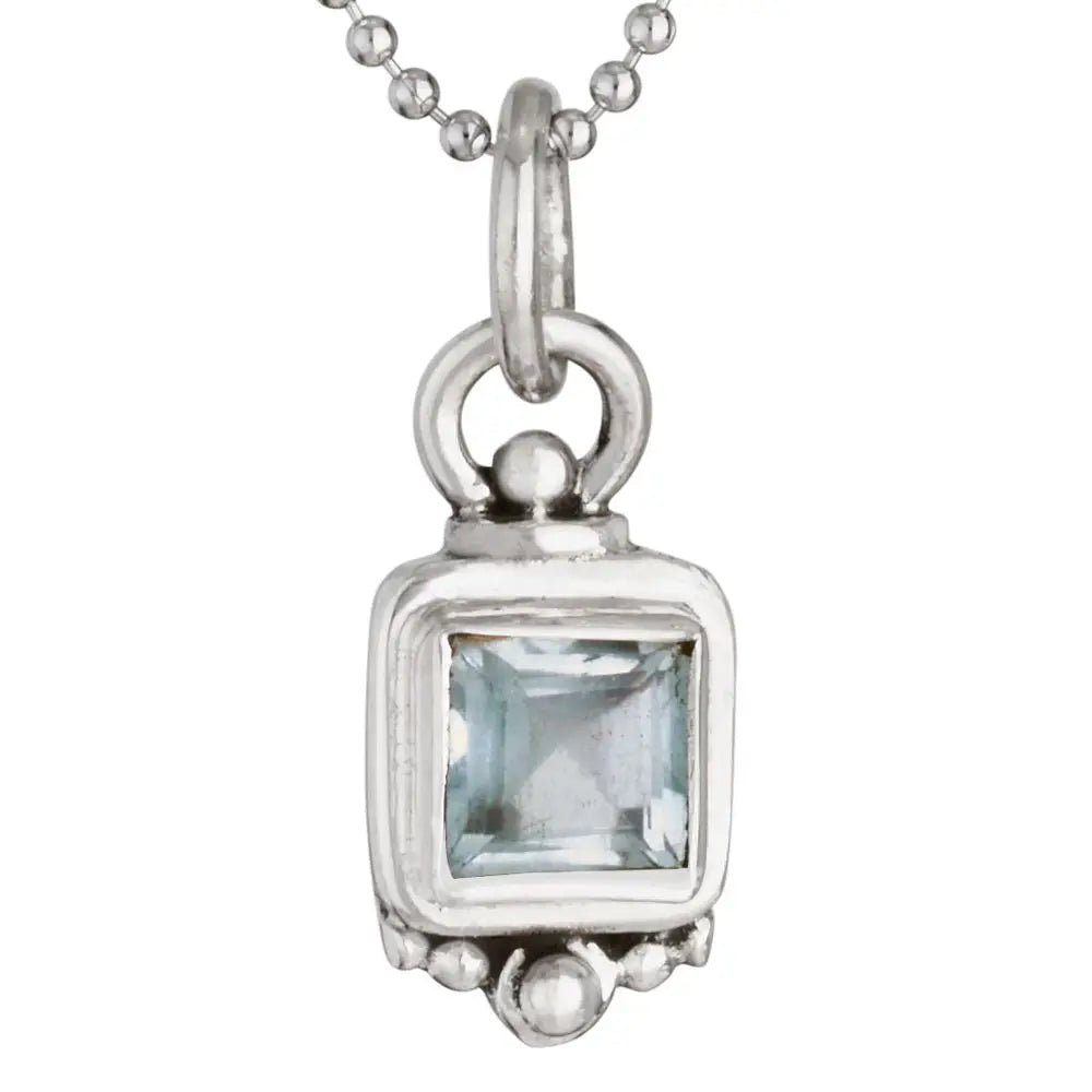 Silver pendant with a rectangular blue gemstone on a white background