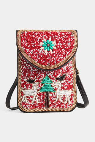 slim black leather bag with whimsical beaded christmas design on the front, featuring red, and white backrground, two reindeer, and a green christmas tree