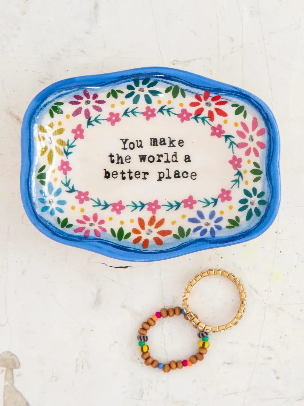 small dish with floral pattern and "you make the world a better place" phrase