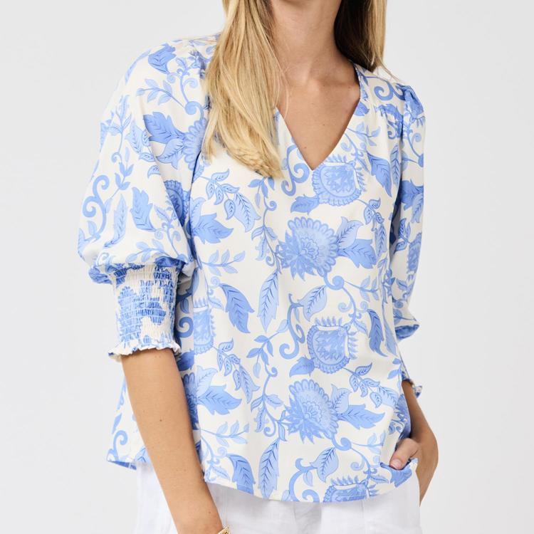 Woman wearing a blue floral blouse on a white background