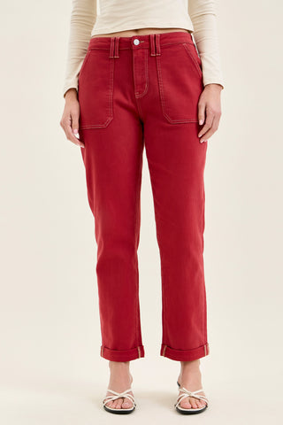 woman wearing dark red jeans with rolled cuff