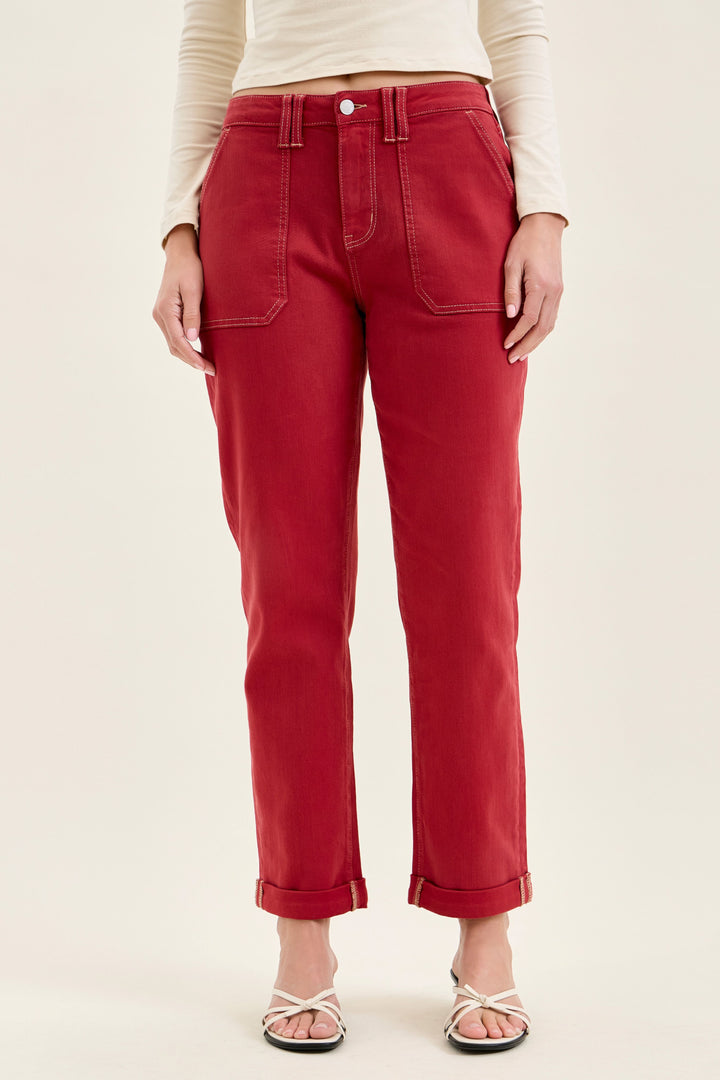 woman wearing dark red jeans with rolled cuff