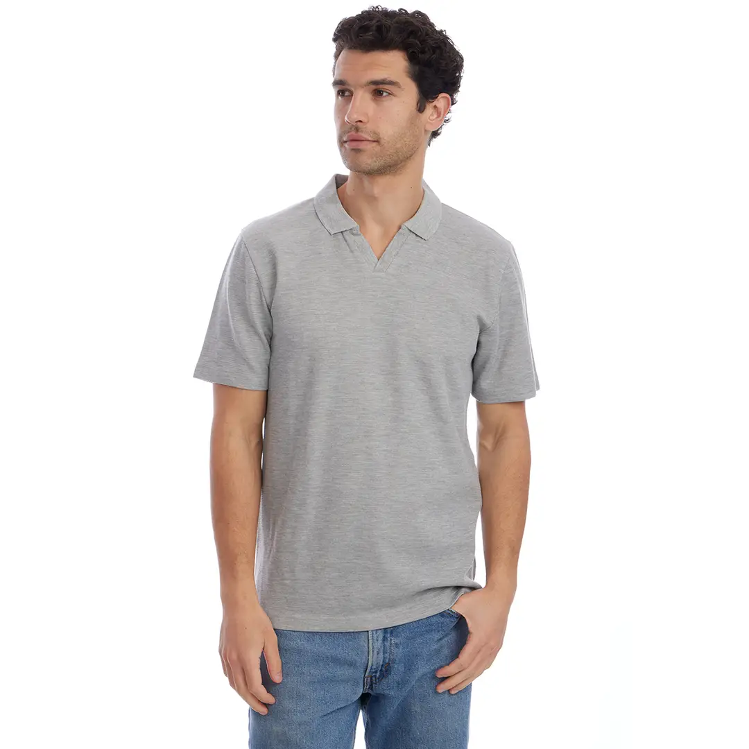 Man wearing a gray polo shirt and blue jeans on a white background
