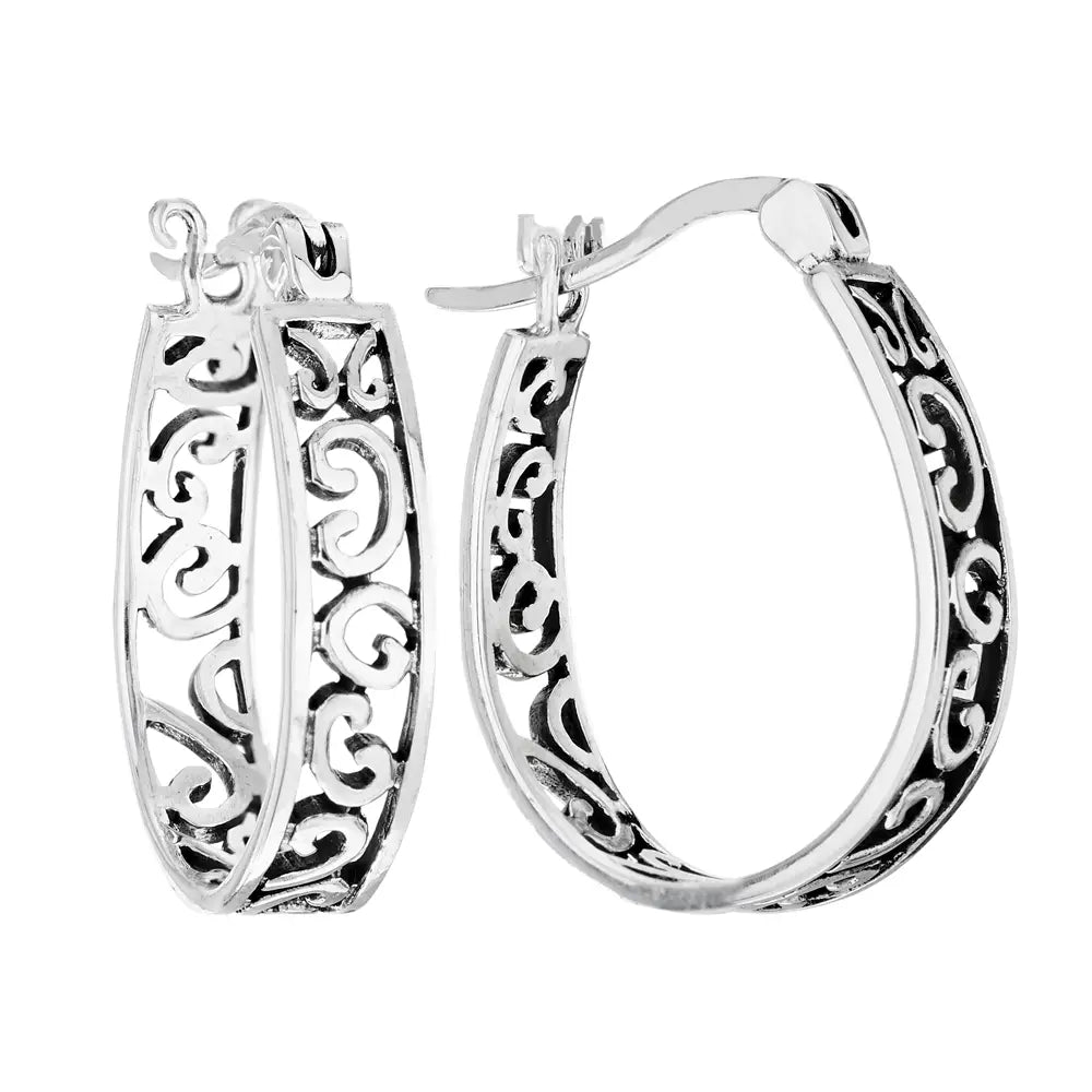 Silver hoop earrings with intricate designs on a white background