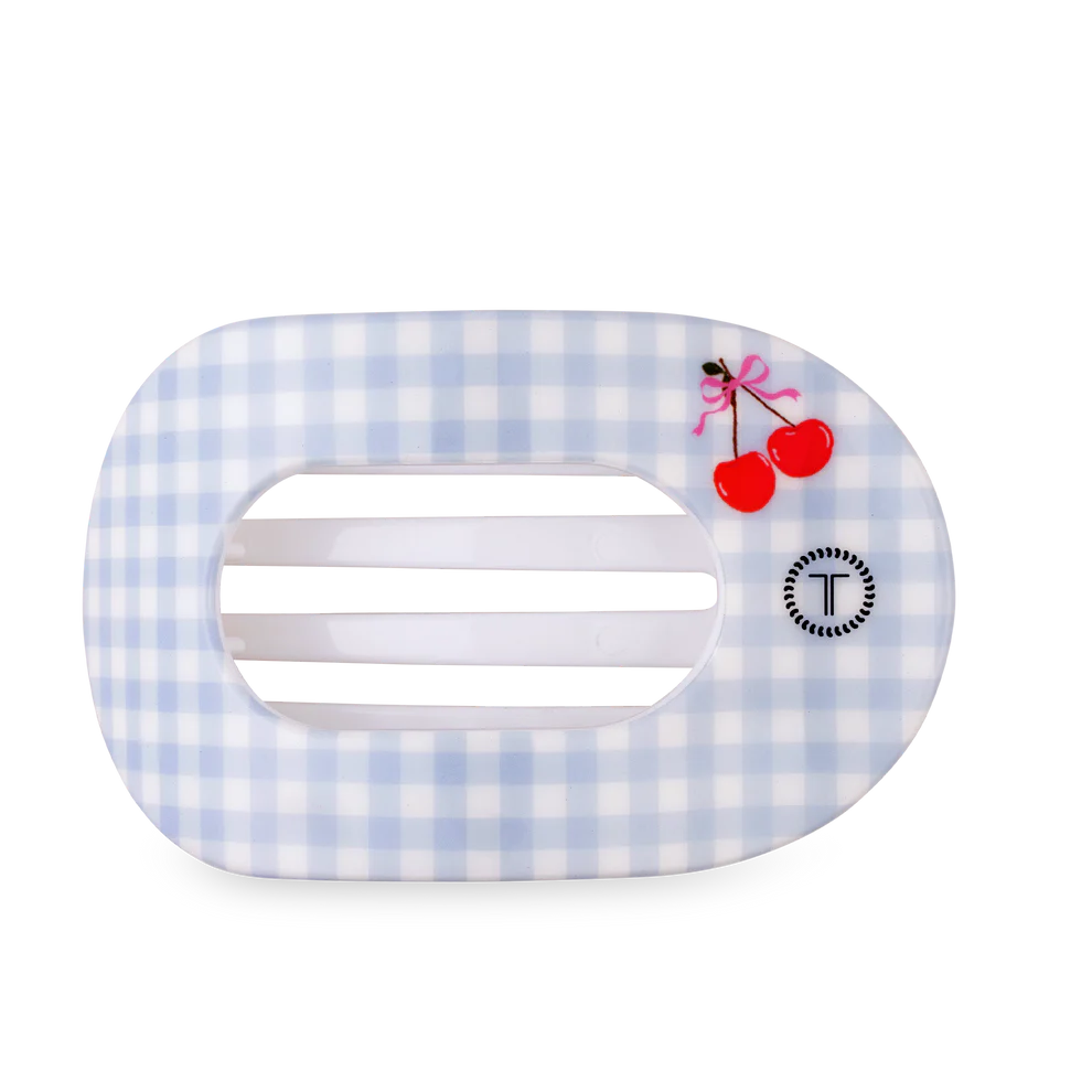 Hair clip with blue and white checkered pattern and cherry design on a white background