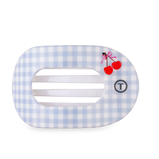 Hair clip with blue and white checkered pattern and cherry design on a white background