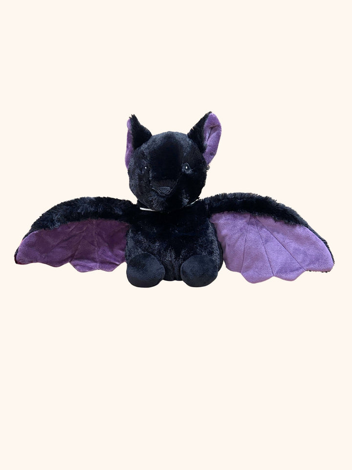 Black plush toy with purple wings on a white background