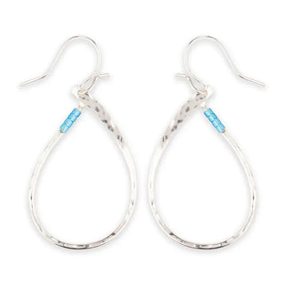 Silver hoop earrings with blue tag on a white background