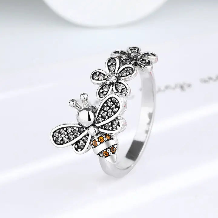 Silver ring with butterfly design on a white background