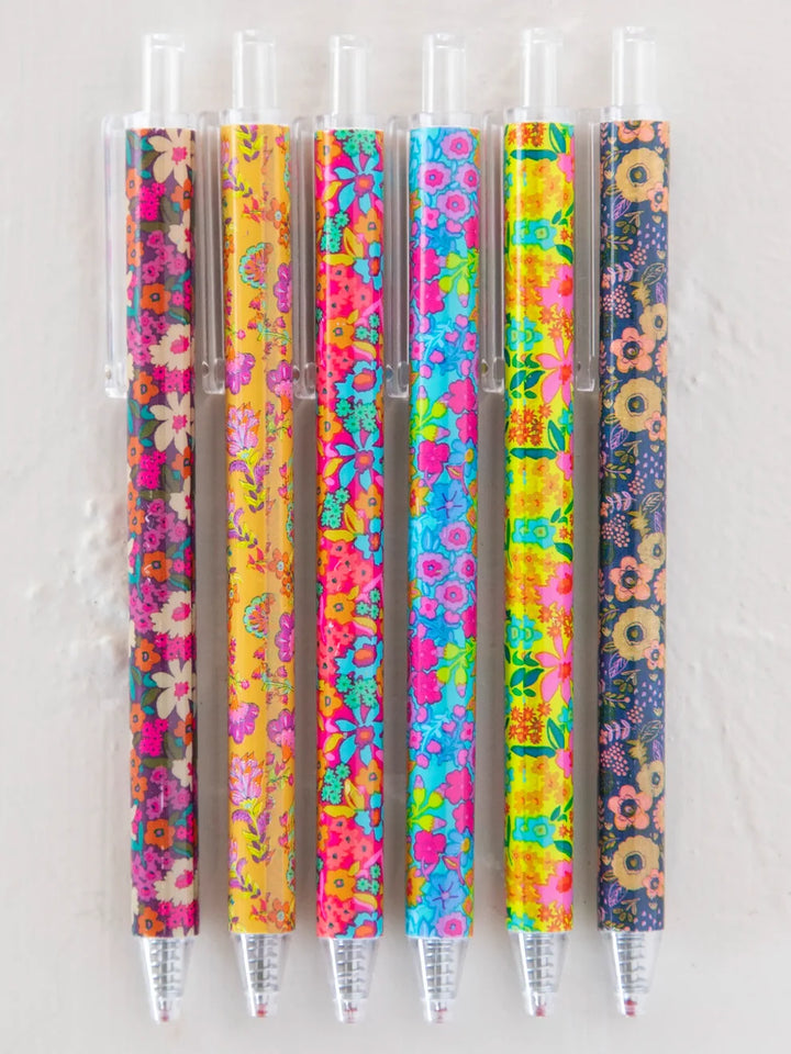 Set of five colorful pens with floral patterns on a white background