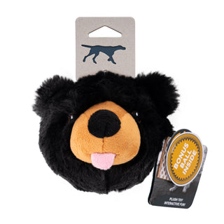 Black plush dog toy with a brown nose and pink mouth, attached to a card with a brand logo on a white background.