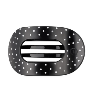 black oval shaped hair clip with white polka dots