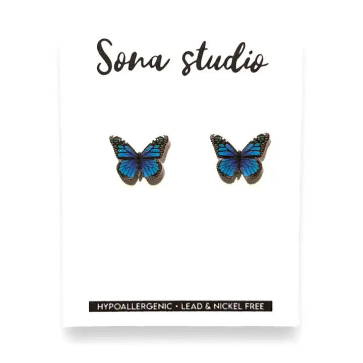 Butterfly earrings on a white card with 'Sona Studio' branding.