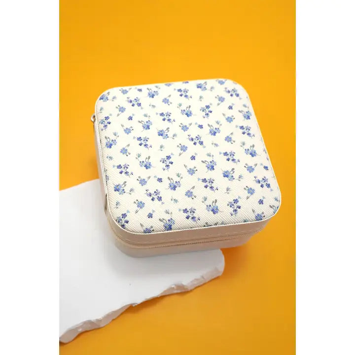 Floral-patterned case on a white surface with an orange background