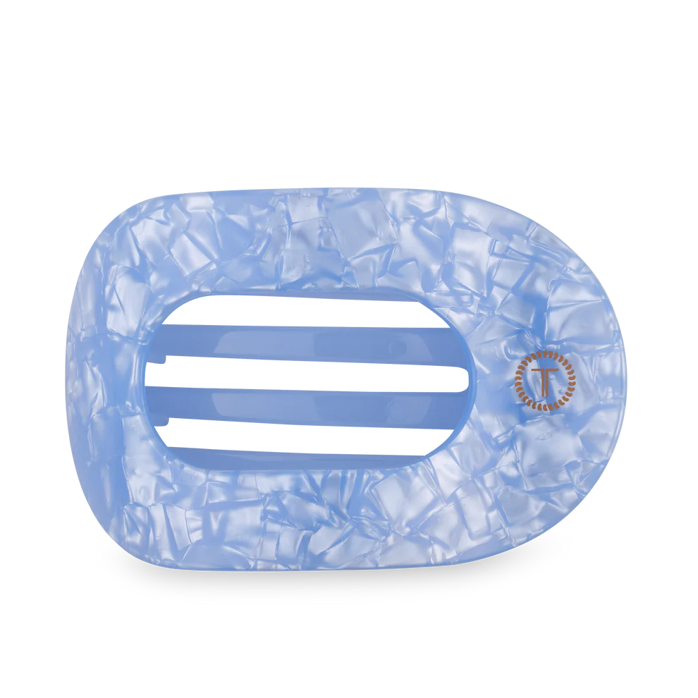 Blue marbled hair clip with a brand logo on a white background