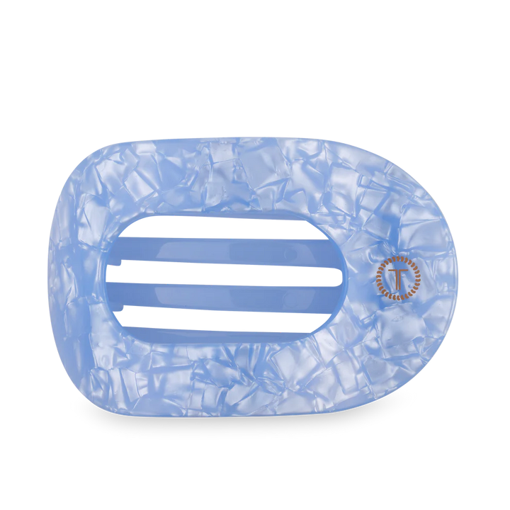 Blue marbled hair clip with a brand logo on a white background
