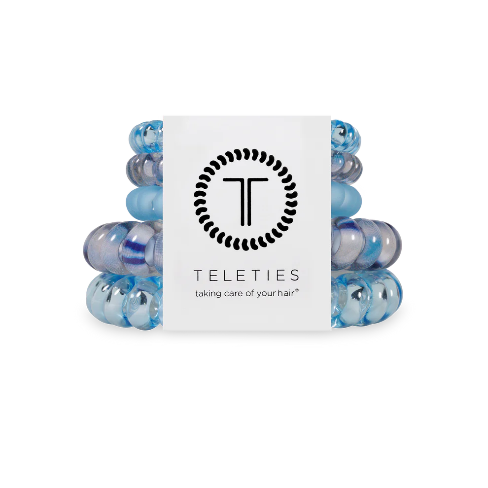 Stack of blue hair ties with a Teleties branded box on a white background