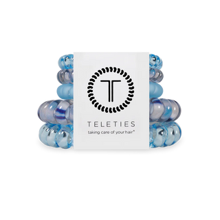 Stack of blue hair ties with a Teleties branded box on a white background