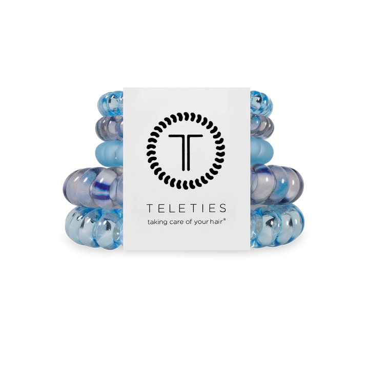 Stack of blue hair ties with a Teleties branded box on a white background