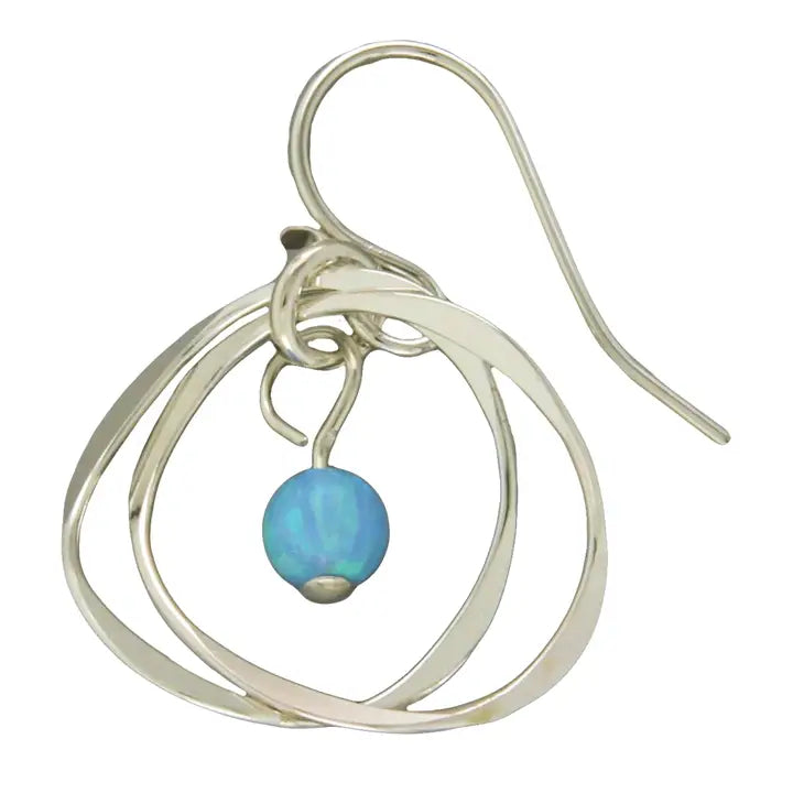 Silver earring with a blue gemstone on a white background
