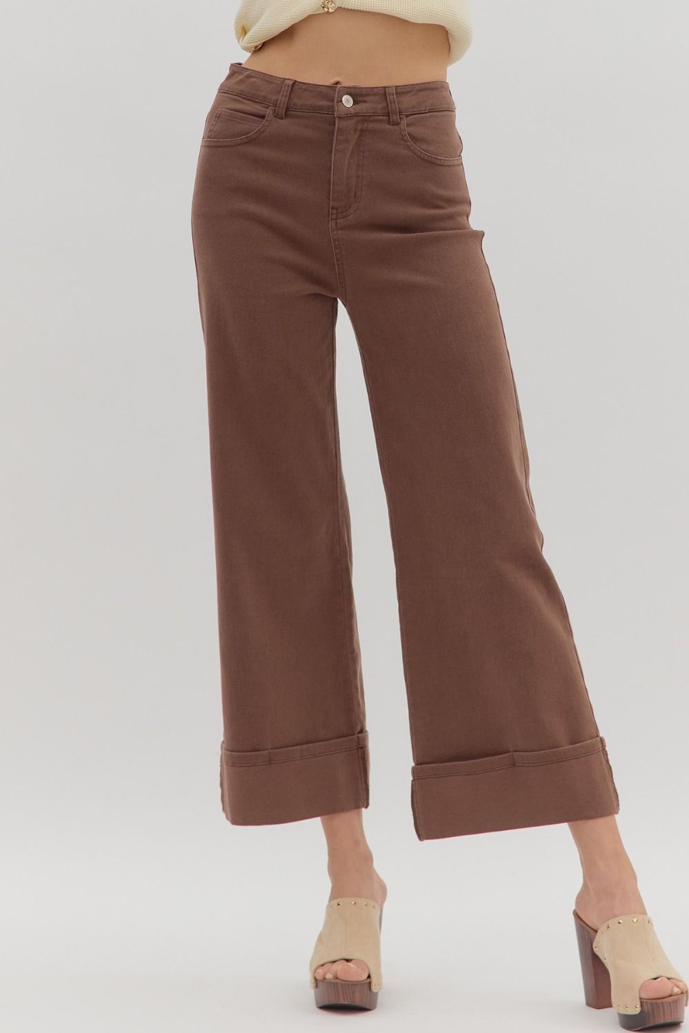 Brown wide-leg pants worn by a person on a white background