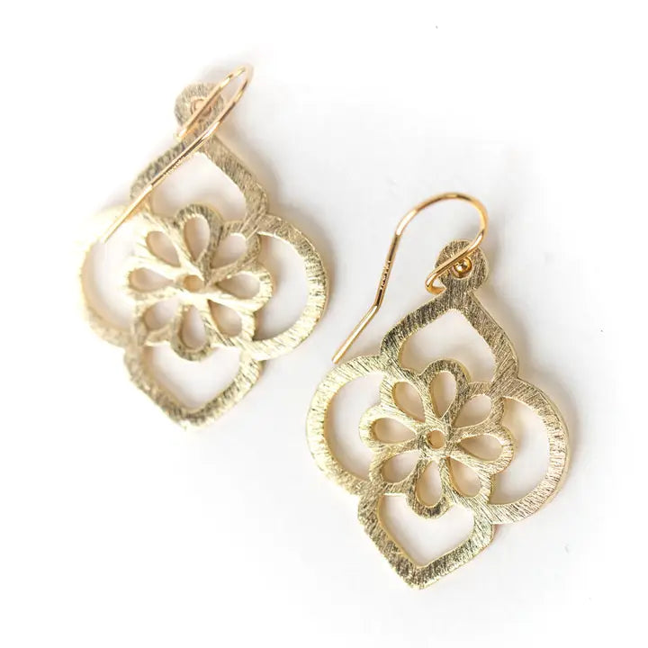 Gold floral earrings on a white background