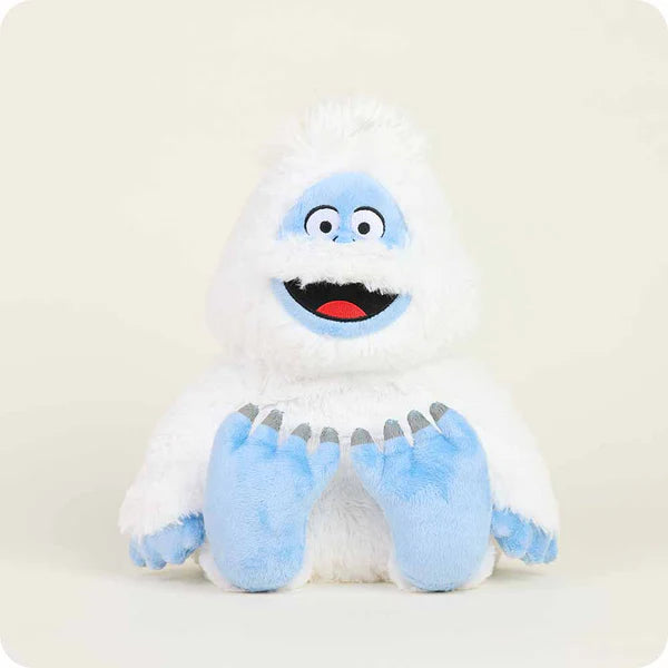 Plush toy resembling a snow creature with a white body, blue accents, and red mouth on a light gray background.
