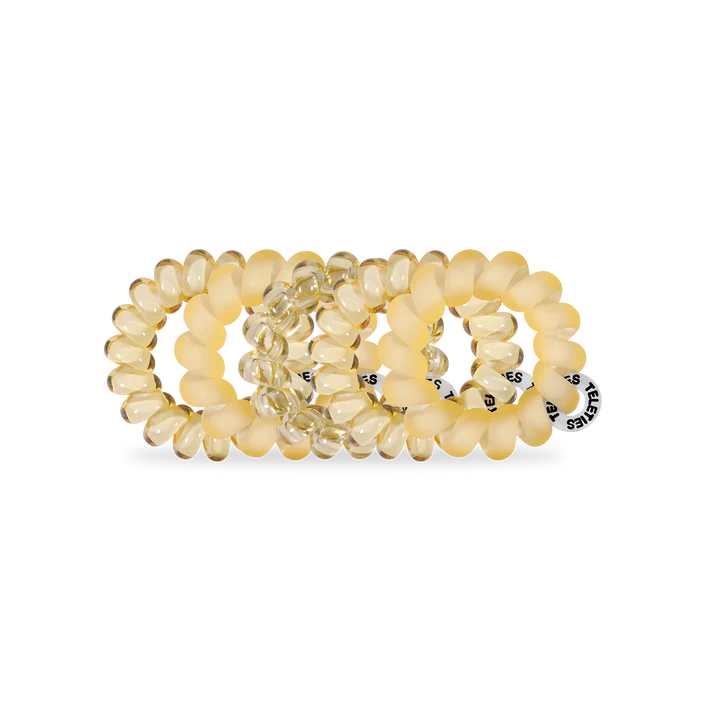 Set of yellow hair ties on a white background
