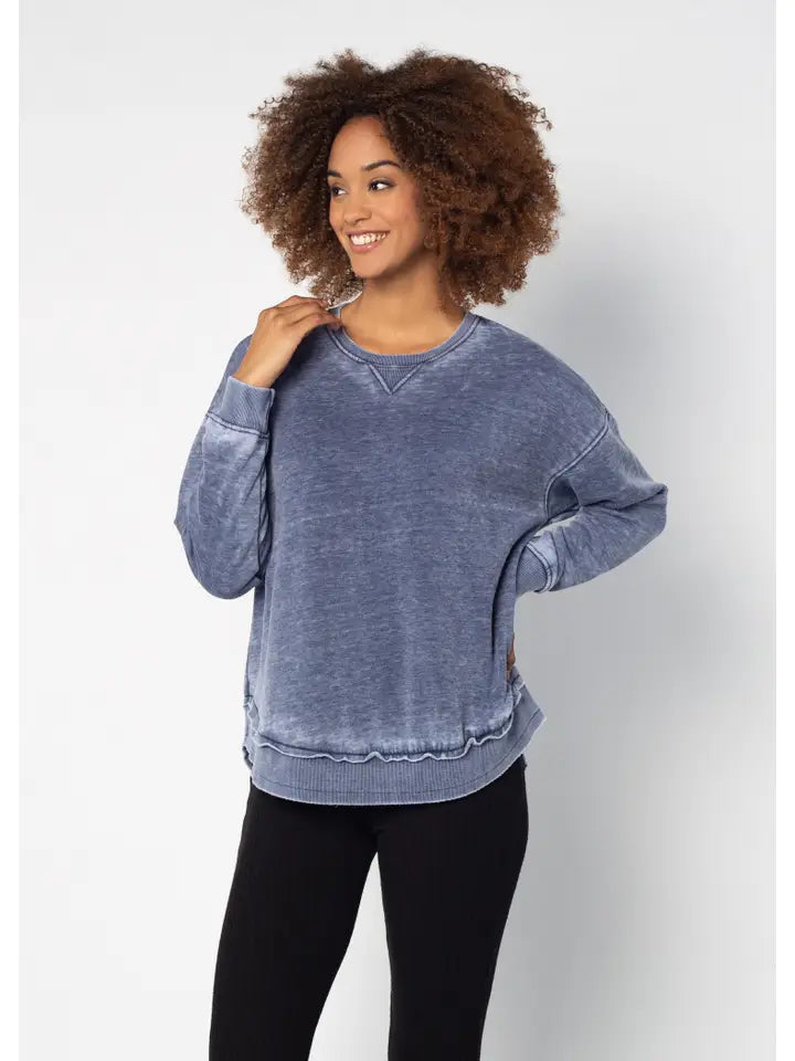 Woman wearing a blue sweatshirt against a white background