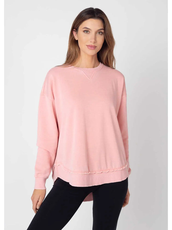 Woman wearing a pink sweatshirt on a white background