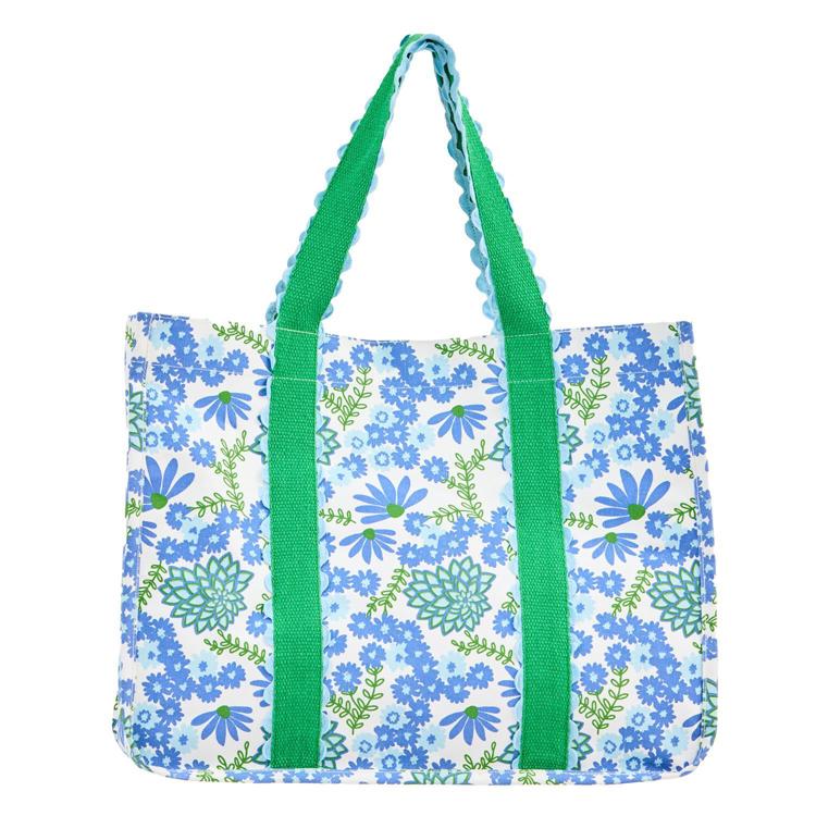 Floral tote bag with green handles on a white background