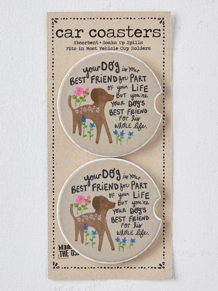 A package of two car coasters featuring a brown deer illustration, colorful flowers, and the text &