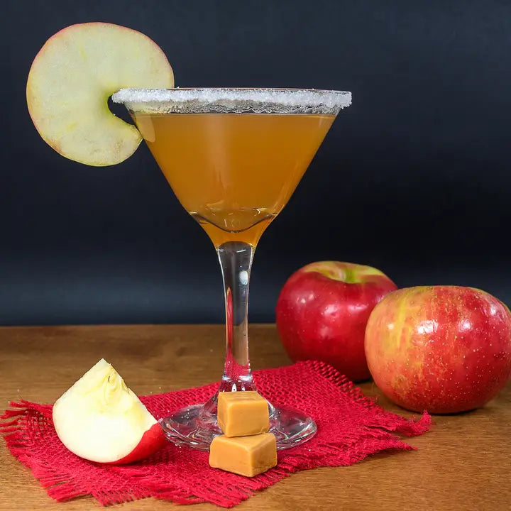 Apple-themed cocktail with an apple slice on a dark background