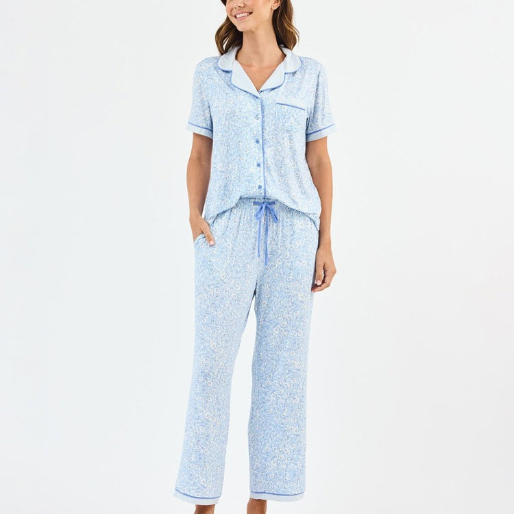 Woman wearing a light blue pajama set on a white background