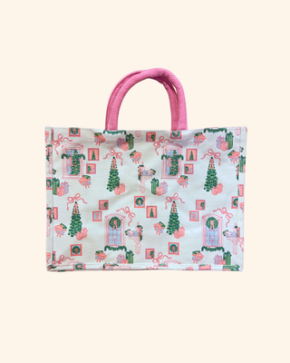 white bag with green and pink designs of trees, gifts, wreaths, and bows