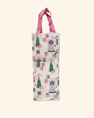 white bag featuring playful pink and green illustrations—featuring gifts, bows, and classic Christmas trees