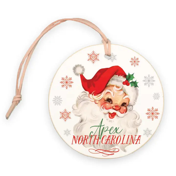 Decorative Christmas ornament with Santa Claus face and 'Apex North Carolina' text on a white background.