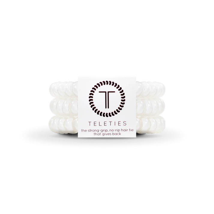 White hair ties with a brand label on a white background